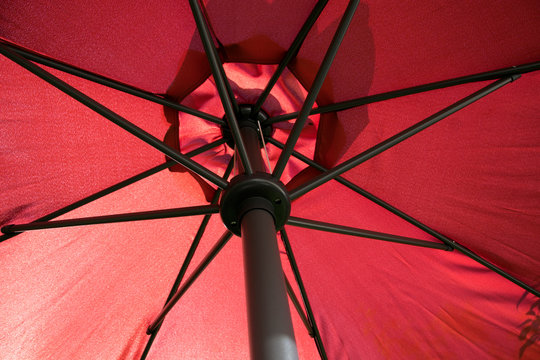 A red parasol photographed from below