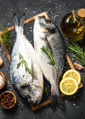 Raw dorado fish on black