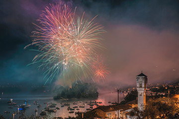 Firework of San Giovanni Festival on Lake Como at Ossuccio with the bell tower