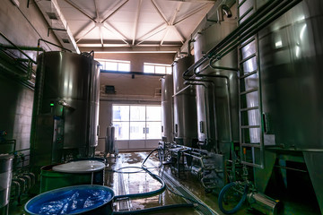 Large steel tanks or reservoirs in beverage factory inderior, industrial hardware equipment