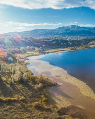 Lake Alserio aerial shot with mountains behind
