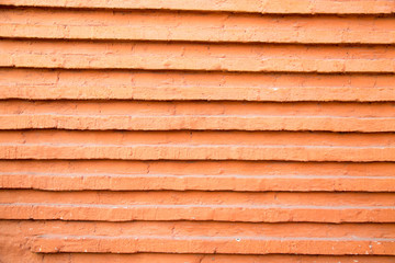 Brickwork of red brick with projecting horizontal rows. Architecture design details construction.