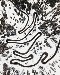 Aerial shot of the Maloja Pass on the Swiss Alps with snow