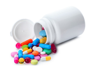Scattered pills and open container isolated on white