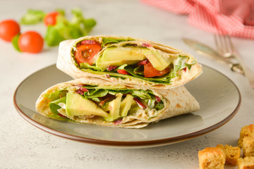 Wraps or torttila. Avocado, vegan wrap sandwiches. Healthy food.