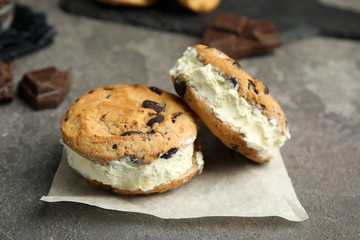 Sweet delicious ice cream cookie sandwiches on table