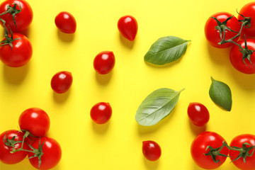 Naklejka na ściany i meble Flat lay composition with ripe cherry tomatoes and basil leaves on color background