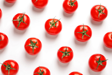 Composition with ripe cherry tomatoes on white background, top view