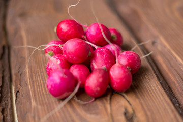 Fresh red radish on wooden background.