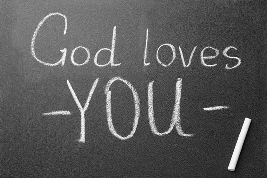 Chalkboard with words GOD LOVES YOU, top view