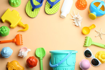 Flat lay composition with bright beach toys on color background. Space for text