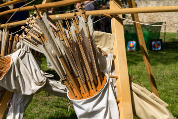 Hand crafted wooden arrows in medieval style on the feather