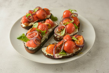 Bruschetta with cherry tomatoes and cheese cream. Healthy, vegan food, snack.