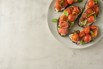 Bruschetta with cherry tomatoes and cheese cream. Healthy, vegan food, snack.