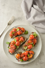 Bruschetta with cherry tomatoes and cheese cream. Healthy, vegan food, snack.