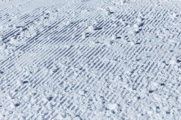 Snow on the prepared ski slopes sunny winter day