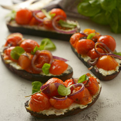 Bruschetta with cherry tomatoes and cheese cream. Healthy, vegan food, snack.
