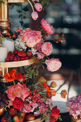 Wedding table flowers with fruits and berries decor in red white pink green colors.