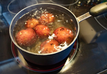 Red potatoes in boiling water