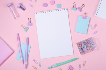 School background with notebooks and pastel colorful study accessories on pink background Back to school concept with copy space for text