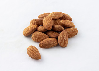 group of almonds without shells on white background