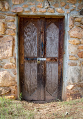 Stone storage shed with wooden door