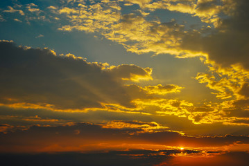 Zachód słońca z chmurami na tle niebieskiego nieba