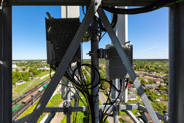Telecommunication tower or mast with microwave, radio panel antennas, outdoor remote radio units,...