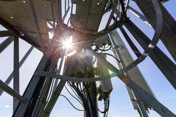 Telecommunication tower or mast with microwave, radio panel antennas, outdoor remote radio units,...
