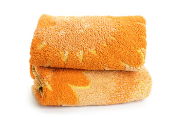 two orange towels stacked on a white background