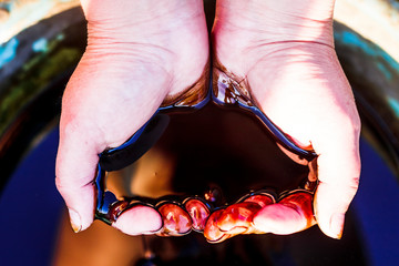 man, hand pour oil into it. have toning. close-up.