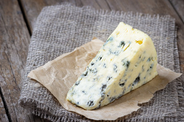 Blue cheese on wooden rustic table.