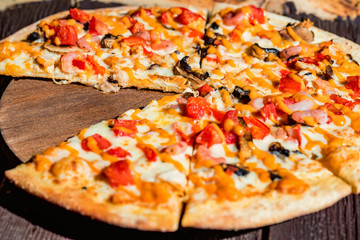 Delicious fresh pizza with tomatoes, mushrooms and cheese close up