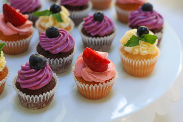 Tasty cupcakes on wedding table, closeup