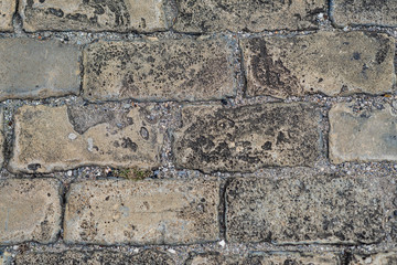 Close up stone pavement view from the top. Top view of stone pavement, texture. Granite cobblestoned pavement background