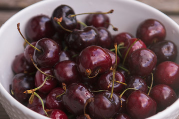 Fresh cherry on plate on wooden blue background. fresh ripe cherries. sweet cherries.