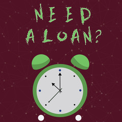 Conceptual hand writing showing Need A Loan question. Concept meaning amount of money that is borrowed often from bank Colorful Round Analog Two Bell Alarm Desk Clock Hand photo