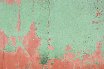 Green plaster on the wall of red plaster.