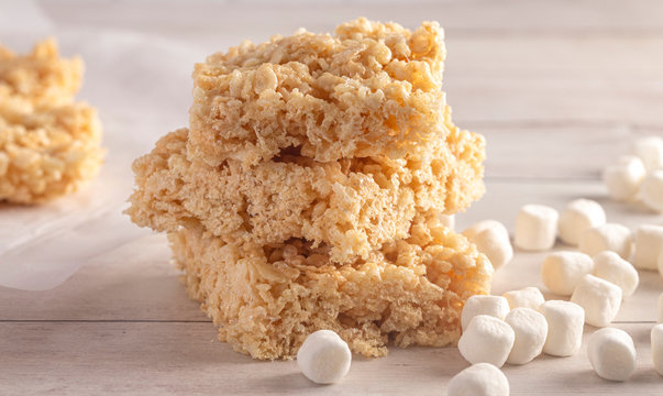 Marshmallow Crispy Rice Cereal Treat Bars on a Wooden Table