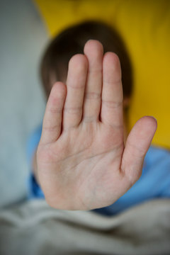 Teenage boy saying no with palm of hand