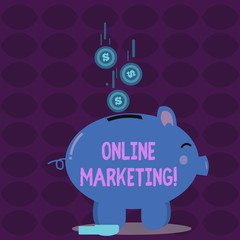 Conceptual hand writing showing Online Marketing. Concept meaning leveraging web based channels spread about companys brand Piggy Bank Sideview and Dollar Coins Falling Down to Slit