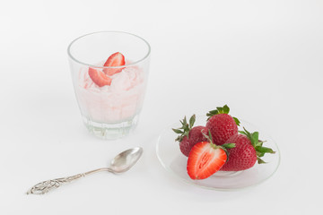 Delicious strawberry ice cream scoop with fresh strawberries on wooden background