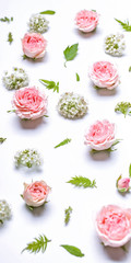 Vertical web banner flower pattern: rosebuds, hawthorn flowers, rowan leaves on a white background. Top view