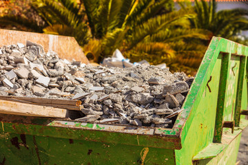 Metal container with construction waste rubble