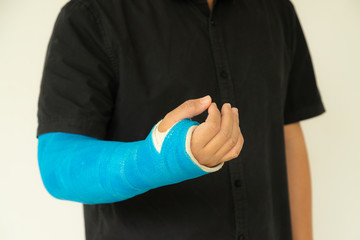 Broken hand injury, Asian man with hand operation with pressure bandage, Hand with wrapped plaster and arm sling.