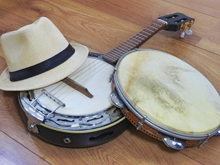 A samba player (sambista) hat and two Brazilian musical instruments: a samba banjo and a pandeiro...