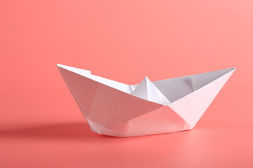 paper ship on a pink background.
