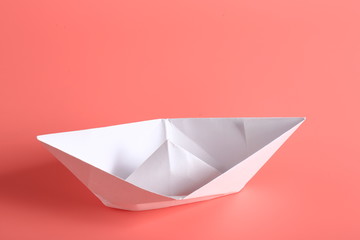 paper ship on a pink background.