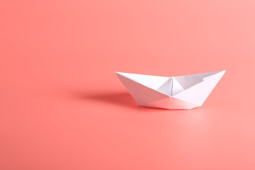 paper ship on a pink background.