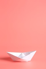 paper ship on a pink background.